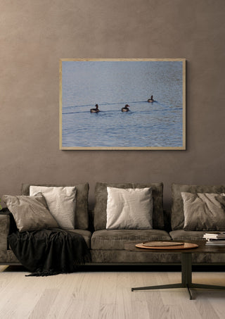 I det fria by Ljilja Marinic in a light oak frame on a warm grey wall above a brown sofa