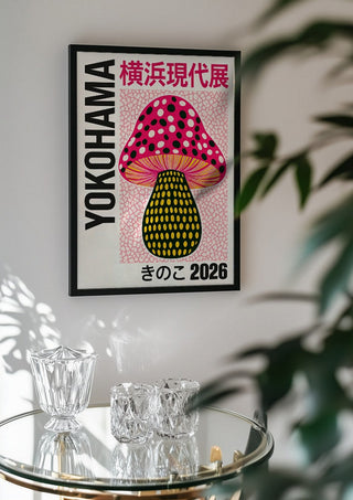 Pink Dot Mushroom Poster by Yokohama in a black frame above a glass table with crystal glassware
