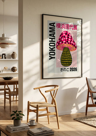 Pink Dot Mushroom Poster by Yokohama in a black frame in a bright dining room with wooden chairs