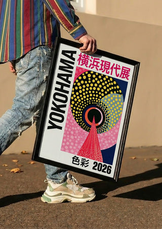 Circles and Colour by Yokohama carried in a black frame along a sunny street