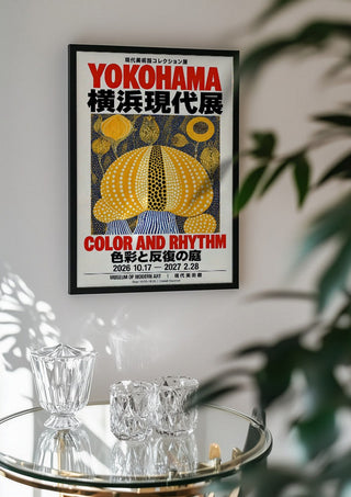 Color and Rhythm Poster by Yokohama in a black frame above a glass table with crystal glassware