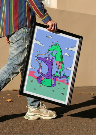 Crocodiles Friends by Elisa Albanelli carried in a black frame along a sunny street