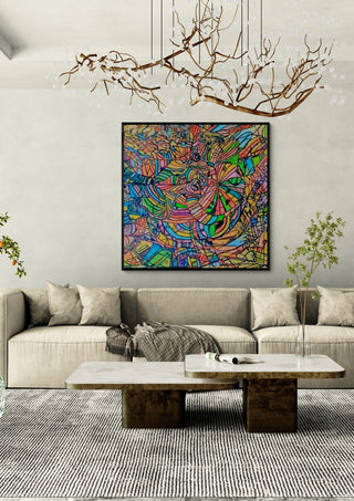 Colour Mosaic by Ronald Rumell in a black frame above a pale sofa under a branch chandelier