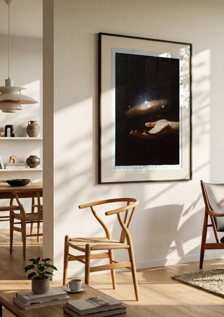 Supernova by Fran Rodriguez in a black frame in a bright dining room with wooden chairs