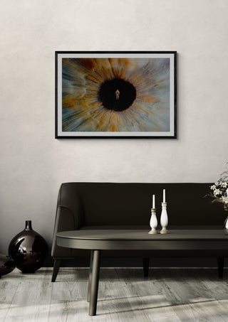 Inner Space by Fran Rodriguez in a black frame above a dark sofa with candlesticks