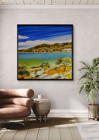 Dalmatia by Sunny in a black frame above a pink armchair beside a potted palm
