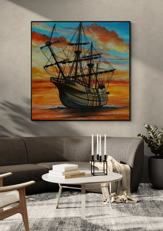 Beautiful Sailing by Sunny in a black frame above a grey sofa with a round table and candlesticks