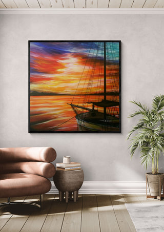 Sunset in red by Sunny in a black frame above a pink armchair beside a potted palm