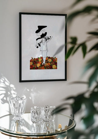 The weight of the world by Madame Petit in a black frame above a glass table with crystal glassware