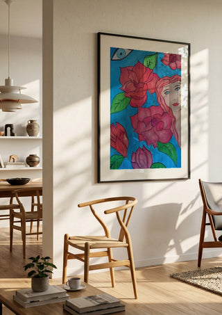 The watching Eye by Carmen Coduri in a black frame in a bright dining room with wooden chairs