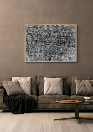 Sirius 33 by Priit Ruttas in a pale wooden frame above a grey sofa with cushions