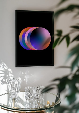 Layers by Aleksi Allan in a black frame above a glass table with crystal glassware