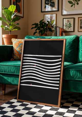 Marbels by Aleksi Allan in a wooden frame leaning against a green velvet sofa on a chequered floor