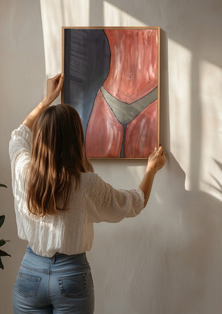 Bare Confidence by Bibi being hung on a sunlit wall