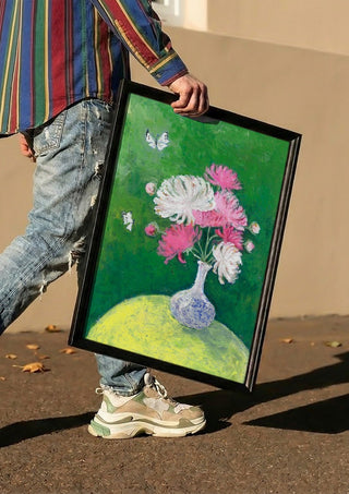 Chrysanthemums by Deblina Dey carried in a black frame along a sunny street