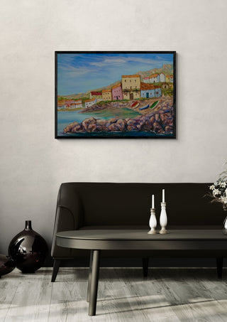 View of La Azohía village by PaKart in a black frame above a dark sofa with white candlesticks