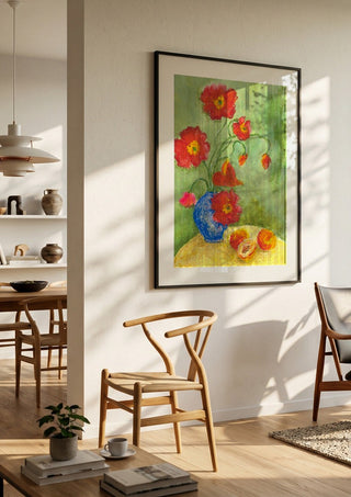 Poppies by Deblina Dey in a black frame in a bright dining room with wooden chairs