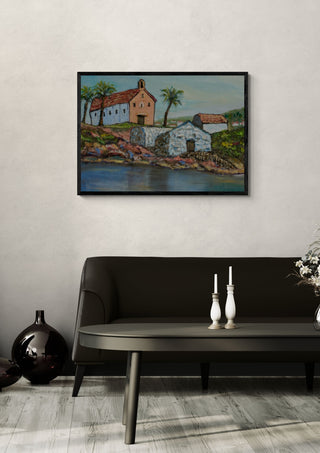 Chapel by the Water by PaKart in a black frame above a dark sofa with white candlesticks