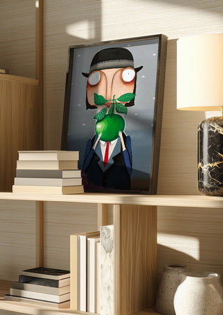 Die Apfelallergie by lacaluna in a dark frame on a wooden shelf beside books and a lamp
