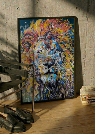 Soul of a Lion by Bibi in a black frame leaning against a concrete wall by a steel chair