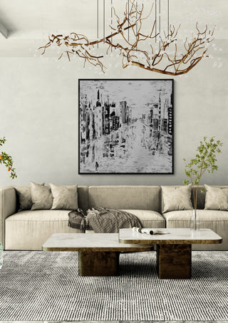 Beyond Time by Sabine Halbrock in a black frame above a beige sofa under a branch chandelier
