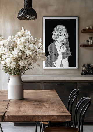 Poppy by Nari in a black frame above a rustic table with white flowers