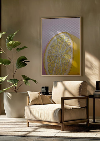 Half Lemon by L.OE. Art framed above a beige armchair beside a potted plant