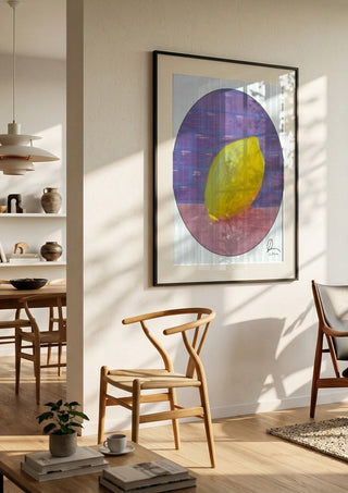 ABCitron by L.OE. Art in a black frame in a bright dining room with wooden chairs