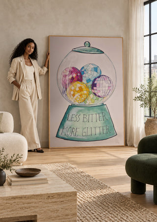 Less Bitter More Glitter by L.OE. Art leaning against a sunlit living room wall beside a woman