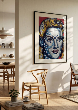 Pinup Girl by Okiana in a black frame in a bright dining room with wooden chairs