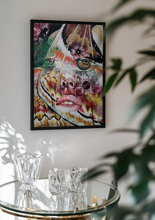 Butterfly Dream by Okiana in a black frame above a glass table with crystal glassware