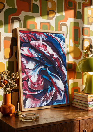 Rose by Okiana in a wooden frame on a sideboard against retro patterned wallpaper