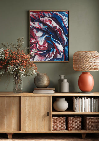Rose by Okiana above a wooden sideboard on a sage green wall
