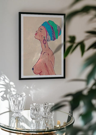 Melanin & Moonlight by Bibi in a black frame above a glass table with crystal glassware