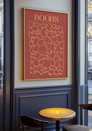 Boobs by Astrid Lind in an oak frame on a panelled café wall