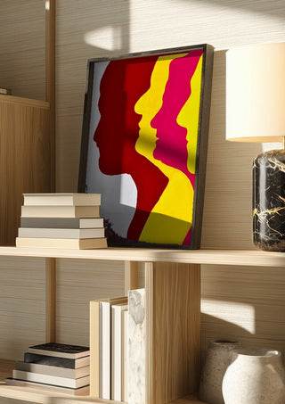 Genesis by Tonia in a dark frame on a wooden shelf beside books and a lamp