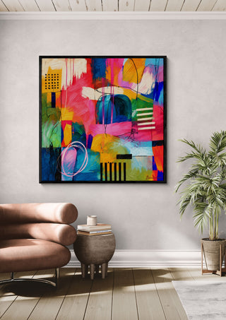 Jazz Puls II by Bondero in a black frame above a pink armchair beside a palm