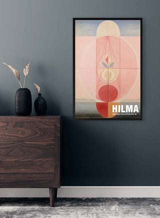 Framed Hilma No 03 - Tara Green abstract art print hanging on a dark wall above a wooden dresser.