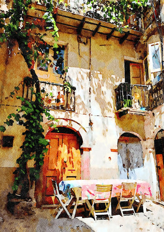 Italian courtyard by Massimo Frascogna - a vine-covered ochre facade with a laid table