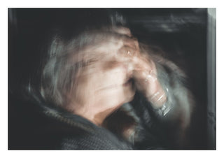 Only human by Lone Gjessing - a figure with hands to the face, blurred by a long exposure
