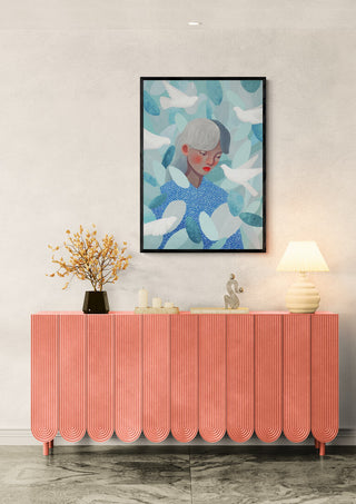 Blue Bird by Martina Karlsson displayed above a pink console table with decor in a modern room.