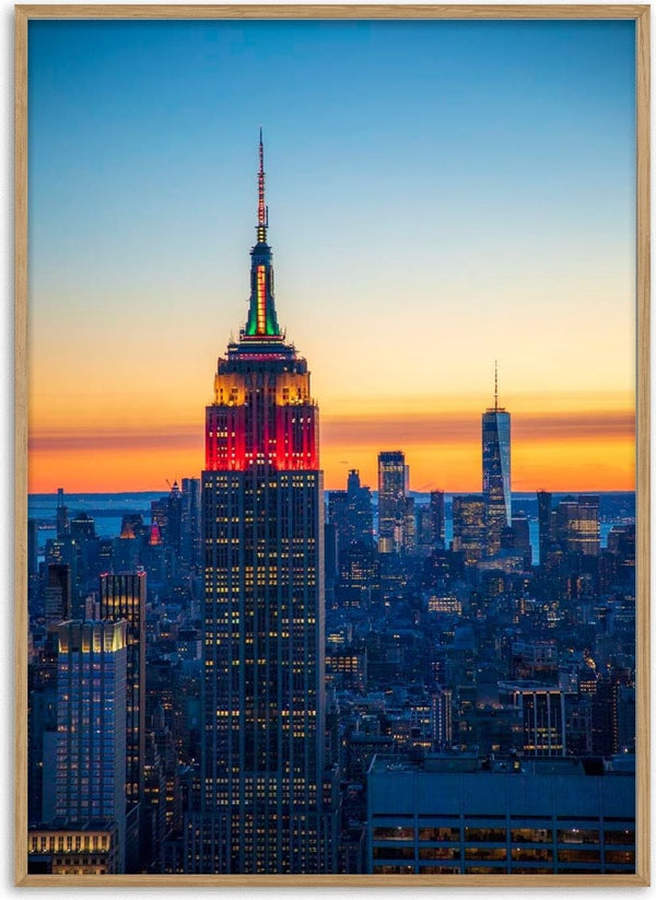 Empire State Building lit up at sunset with Manhattan skyline, featured in Blue Manhattan by Danny Gao.