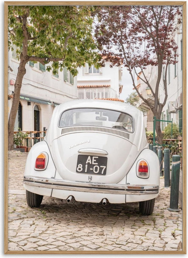 Vintage white car parked on a cobblestone street in Cascais, ideal for Driving Cascais experiences.