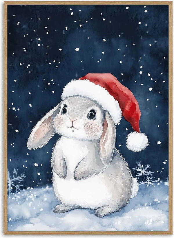 Cute gray bunny wearing a Santa hat sits in the snow with snowflakes falling, perfect for Home for the Holidays.