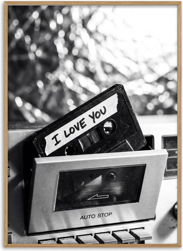 Cassette tape labeled "I Love You" partially inserted in a vintage cassette player.