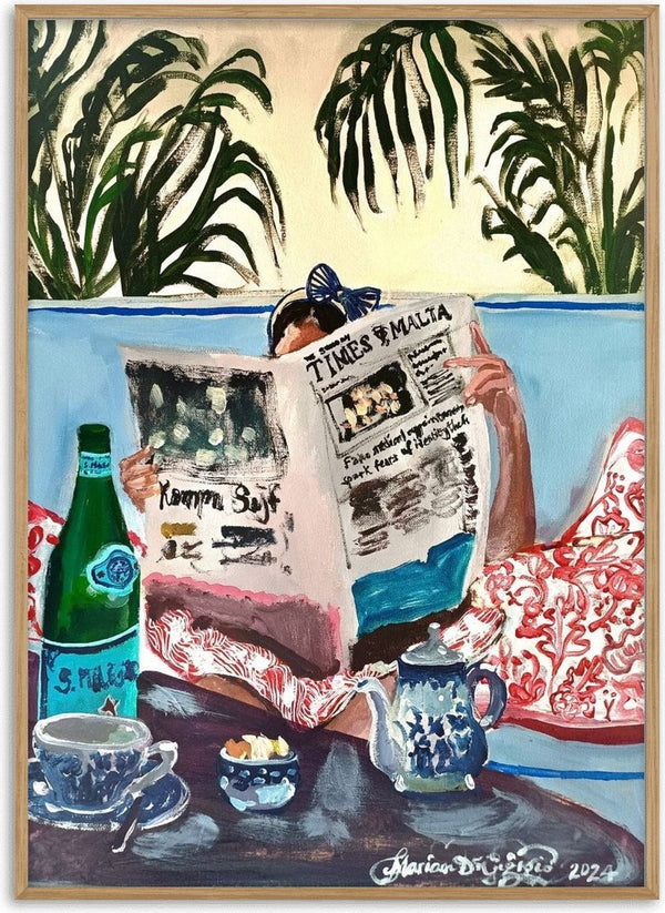 Sunday read at The Phoenicia, Malta by Mariam De Giorgio - a woman reading a newspaper on a blue banquette among palms
