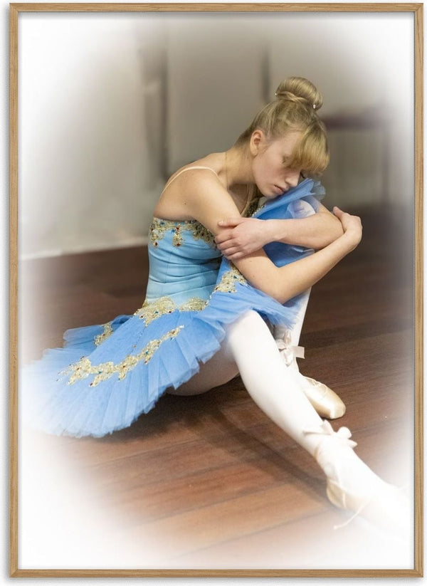 The Russian ballet dancer by Bettinafloorphoto - a dancer in a pale blue tutu seated on a wooden floor