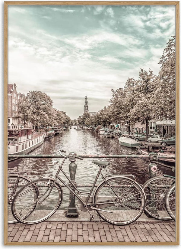 Two vintage bicycles on a bridge over an Amsterdam canal, urban vintage style with cityscape in the background.