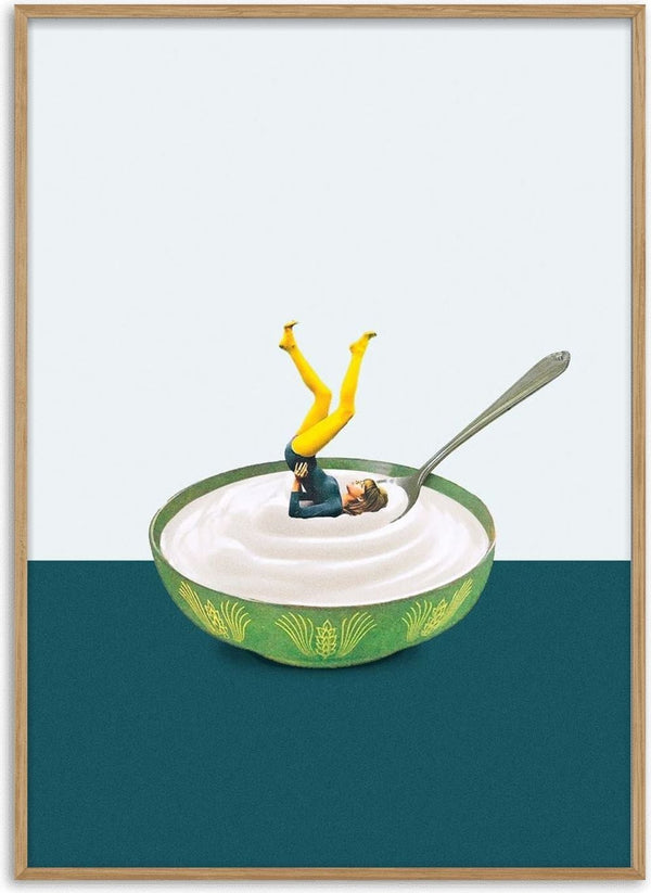 A miniature figure does a yoga pose in a bowl of yogurt with a spoon, promoting Yoga in my yogurt by Maarten Léon.